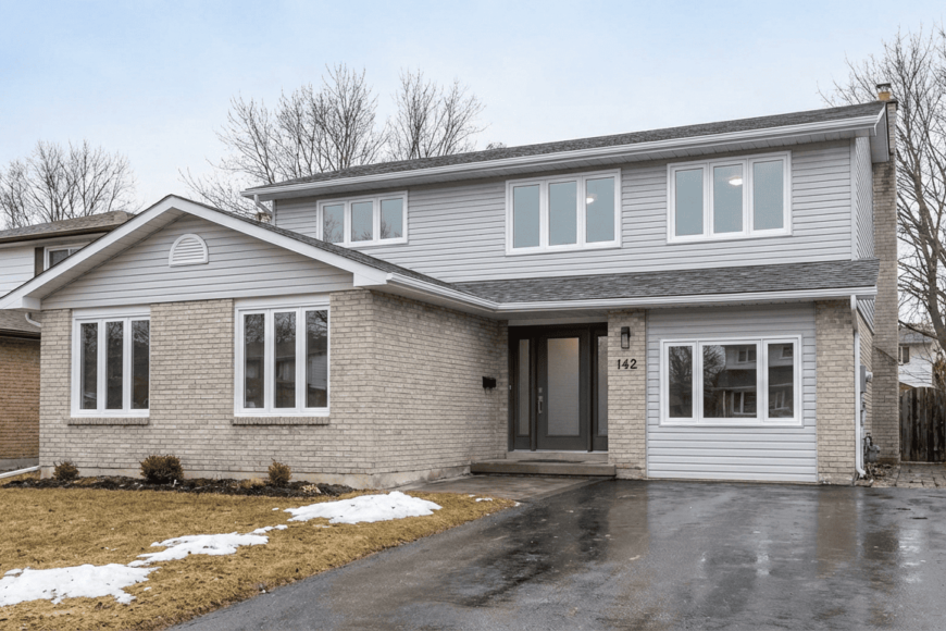 Barrie, Ontario home exterior with new windows and a front entry door.