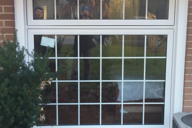 Home window with white frame on a brick exterior in Barrie, ON.