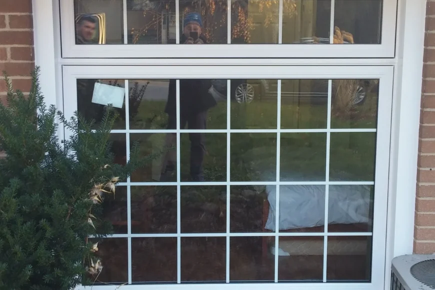 Home window with white frame on a brick exterior in Barrie, ON.